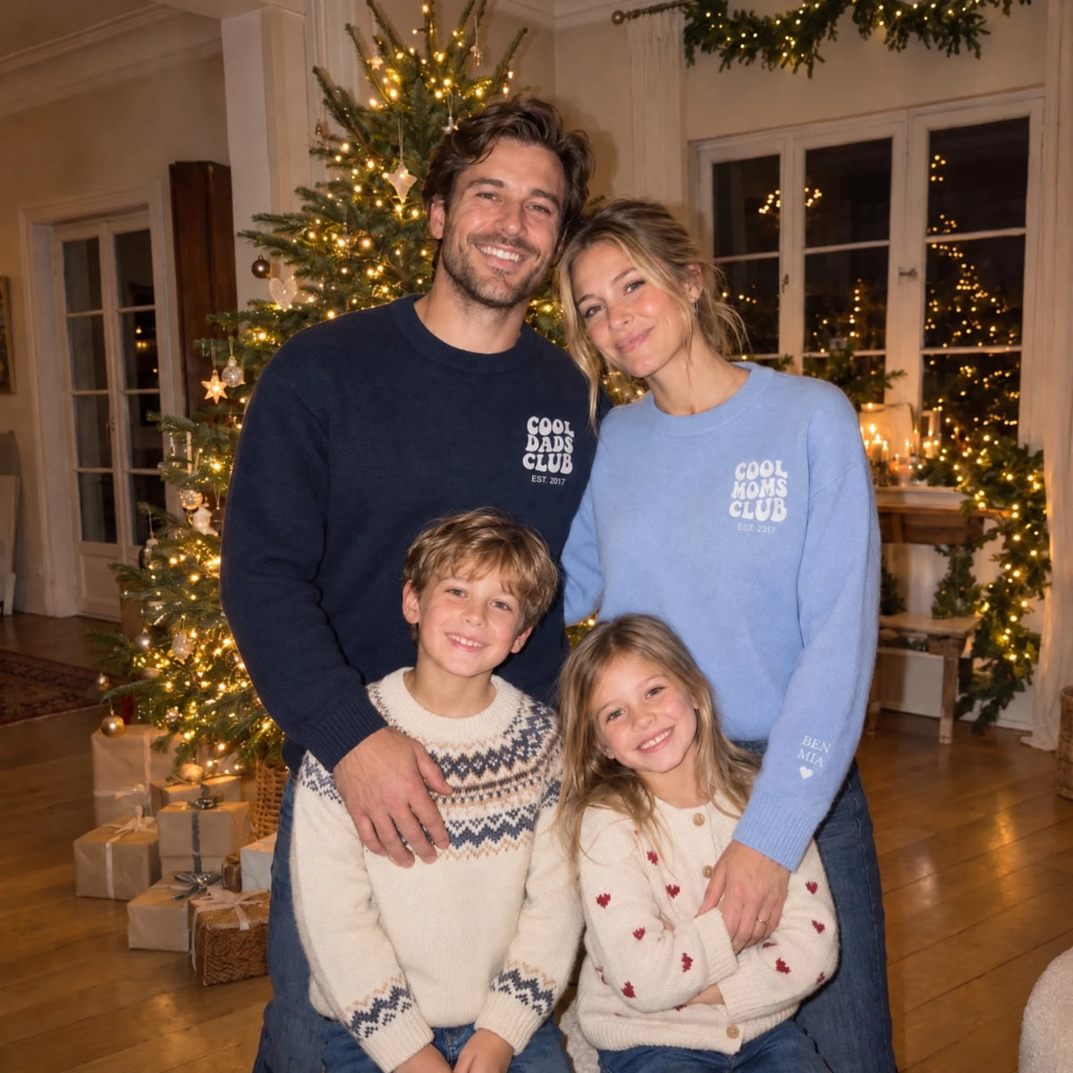 Family at Christmas in Cool Dads Club and Cool Moms Club sweaters